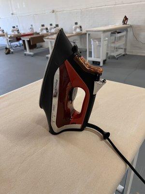 Ironing tables, with a view of some of the machines.