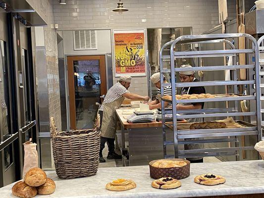 Picture of the bakers hurt at work, making additional baked bread for the afternoon.