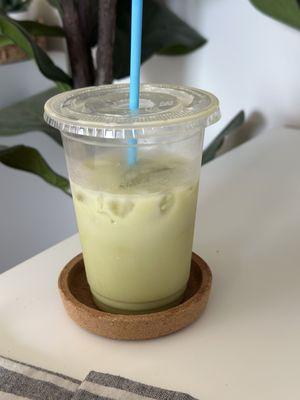 Iced matcha latte with oat milk (half drank)