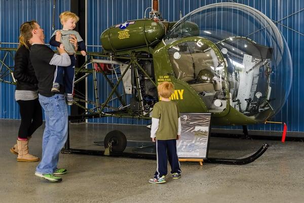 A family inspects the H-13 helicopter