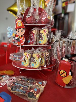 Fire fighter mini dessert bar set up with cookies, cake pops, and chocolate covered pretzels