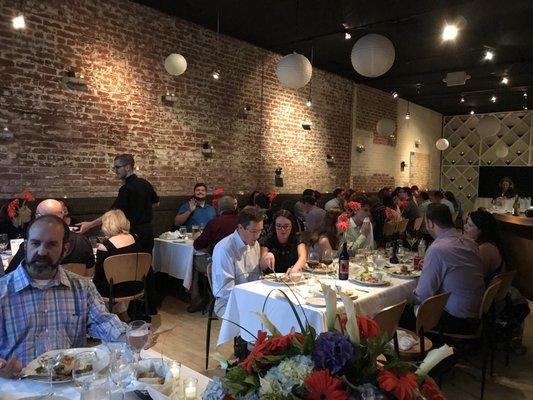 Exposed brick wall and wood finishes over the bar give the venue a Downtown C'ville feel.