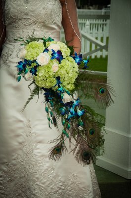 Peacock feathers, white roses, green hydrangeas and noble dendrobium orchids