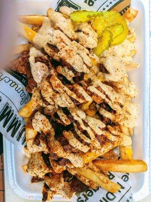 Loaded Nashville Fries Fries topped with Crispy Hot Chicken, Nashville Sauce, Seasoning and Pickle.