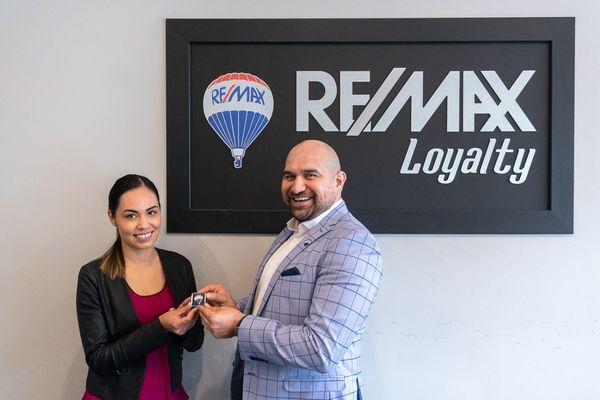 The Santoyo Group - REMAX Loyalty giving the Loyalty Pin to Silva Soto, welcoming her to the team!