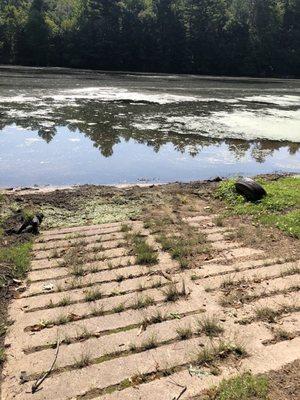 Boat ramp and river covered in algae