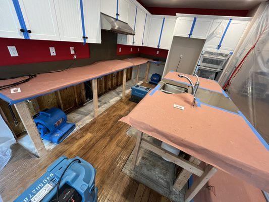 A faulty dishwasher leak led to damage spreading across the entire kitchen. Cabinets were saturated and had to be removed.