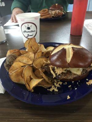 Cowboy burger on a pretzel bun and curly fries!