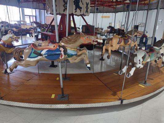 Mid-century carousel not actively in operation. Metal cast horses with some fun paint jobs but no unique shapes like wood carved ones.