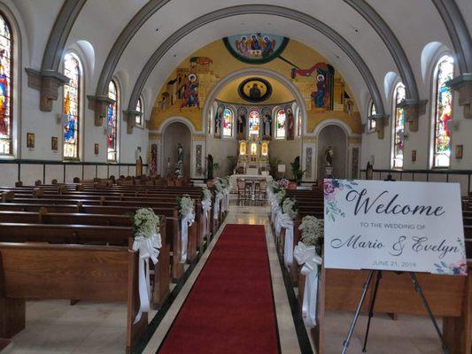 Fiesta Florist made and put up the floral arrangements on the church pews.