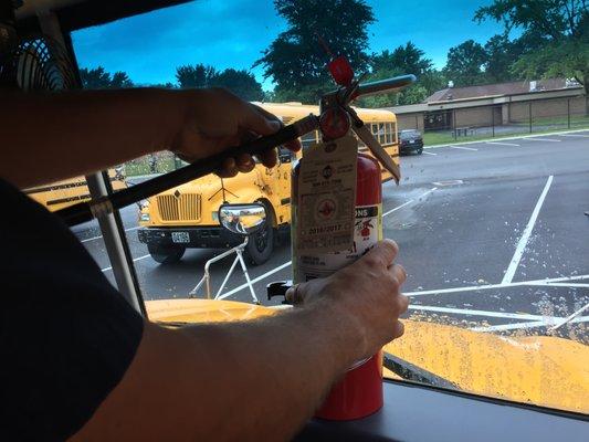 ABCO Fire Protection inspects fire extinguishers on the buses for a local school district