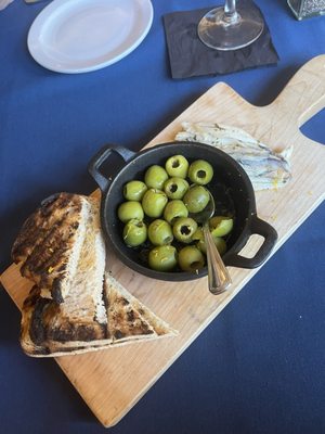 Warm olives with Spanish BOQUERONES with toast points