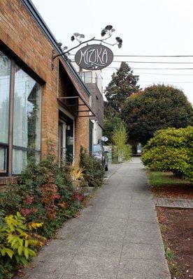 View of the Mizika sign from the sidewalk on 1st Ave NW.