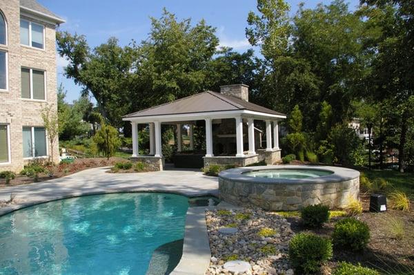 Outdoor living area with masonry chimney, distressed wood ceiling, Azek trim work and metal seem roof.