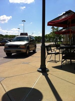 Delivery driver parked on sidewalk ruining nice day in outdoor seating area