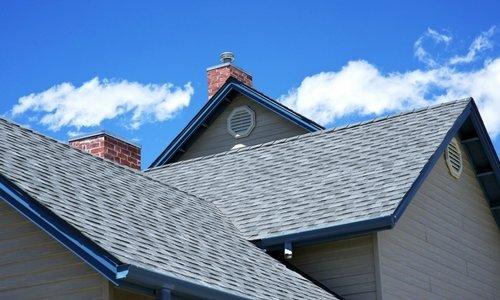 Standard 30-year architectural shingle, grey offset with blue accent eves and gutters.