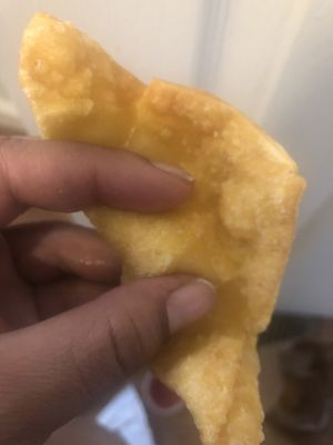 Nickle  size drop of filling between my fingers  and a whole lot of breading