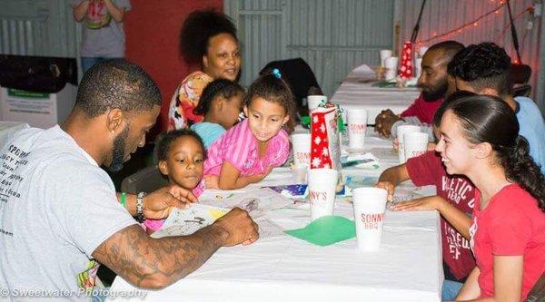 Clint spending time with some of the children at our Annual Feed42 Families event here at HHF