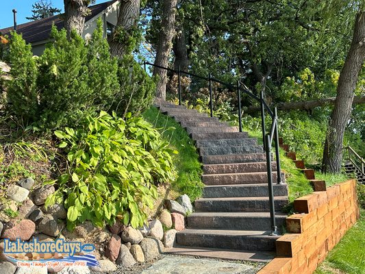 Lakefront staircase, riprap shoreline, and timber retaining walls