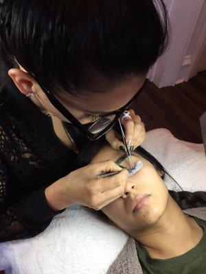 Lash artist Maribel beautifully applying classic eyelashes.