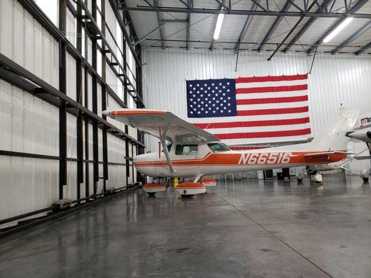 A C-150 in the hangar waiting out a storm.