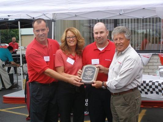 Store Owners Pat & Kris Abold, Manager Michael Silliman and Mario Andretti