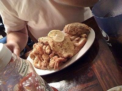 Seafood platter: shrimp, catfish, stuffed crab, hush puppies, fries.