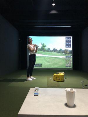 Kelly taking her golf lessons and hard at work