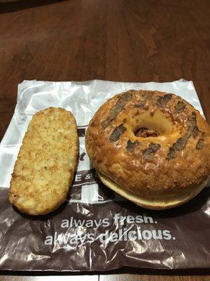 Four cheese bacon, egg bagel sandwich, and a hash brown