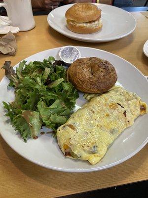 Southwest Omelet with greens and a cinnamon raisin Bagel and Cream Cheese.