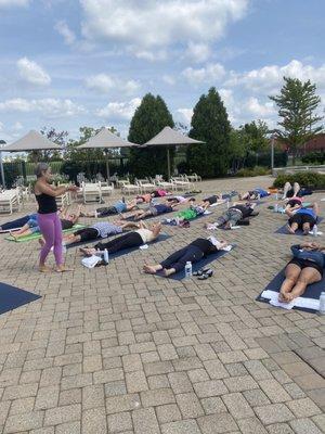 ARORA group fitness members enjoy yoga poolside, mats, towels and bottles of water were provided to us -