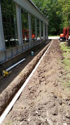 Digging and running all of the downspouts out to ensure water is properly taken away from the building.