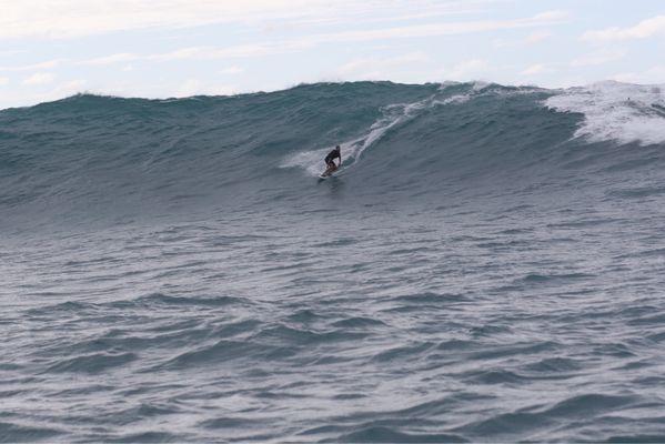 Tow in session at an outer reef on the north shore