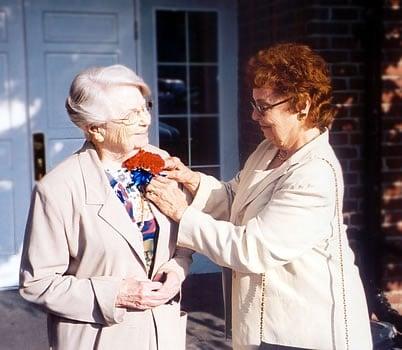 PAYING TRIBUTE --- Former student Mary (McQuaid) Korth Curran pins a corsage on her freshman teacher, Sister of Charity Mary Jul