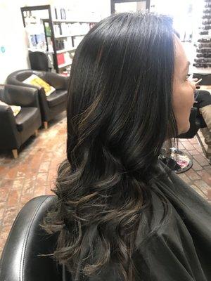 Dark brown with subtle peekaboo highlights with long layers.