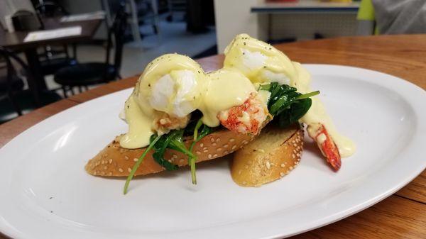 Poached eggs on lobster over french bread with greens.