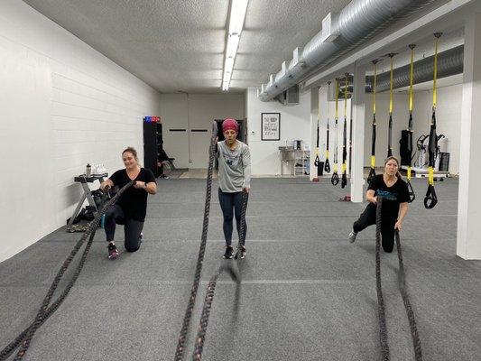 Trainer Rachel (center) and members during battle rope exercises