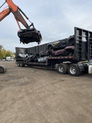 Loading the truck with junk cars and trucks. Go green and recycle your car and get cash for it.