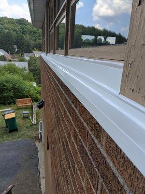 The aluminum siding was added to prevent water seeping in through some chipped wood on the outside of our windows