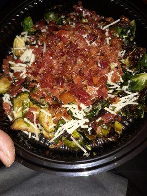 Grilled brussel sprouts with parmesan cheese, special sauce and bacon.