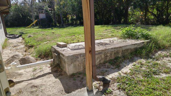 Old gray water tank and elevated drain field normally covered by deck, about to be removed