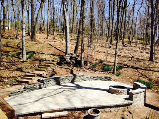 Raised patio with a natural stacked stone Retaining wall and Mini Creta block sitting wall.