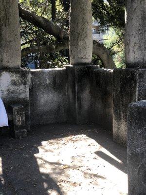 Concrete bench at left, structures