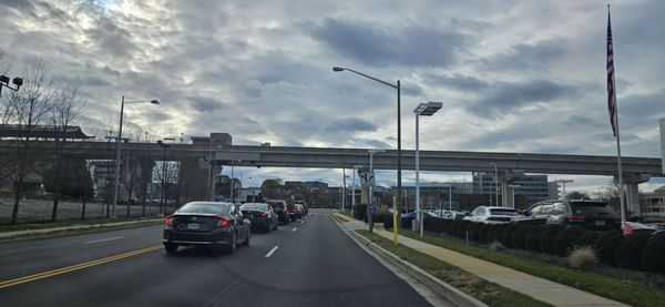 1/12/24 behind me is the Tesla Car Dealership.  I  front if me is Wal-Mart off in the distance.