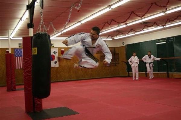 Master Lloyd N. Brown demonstrating a high flying side kick and is over 5 feet in the air!