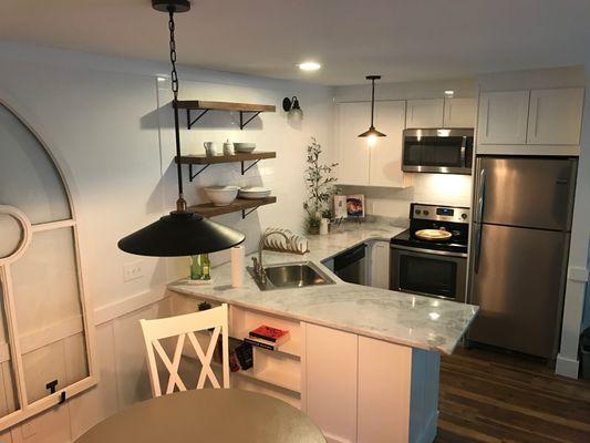 Neat condo setup - new kitchen and tops. Wall tile and shelves