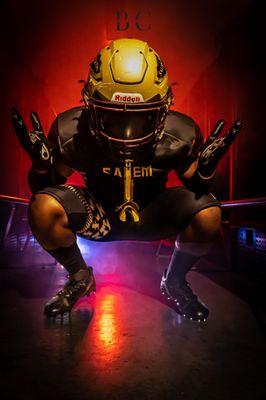 Football Player in locker room pose team