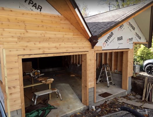 Two car garage construction with cedar siding