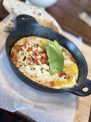 Skillet with tomatoes, feta, and avocado.