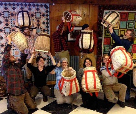 A group of Ely Folk School students showing off their hand-woven baskets